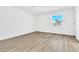 Neutral bedroom features modern wood-like flooring, white walls and a window with natural light at 4880 Hayride St, Las Vegas, NV 89149