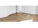 Bright bedroom featuring wood-look flooring, closet and white doors at 4880 Hayride St, Las Vegas, NV 89149