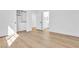 Clean bedroom with wood-look flooring and walk-in closet leading to bath at 4880 Hayride St, Las Vegas, NV 89149