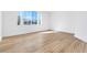 Sunlit bedroom showcasing wood-look flooring and large windows at 4880 Hayride St, Las Vegas, NV 89149