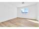 Minimalist bedroom features wood-look flooring and a bright window at 4880 Hayride St, Las Vegas, NV 89149