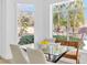 Charming breakfast nook features a glass table and a view of the lush backyard and pool at 4880 Hayride St, Las Vegas, NV 89149