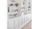 Built-in shelves and storage with custom molding detail and light hardwood floors at 4880 Hayride St, Las Vegas, NV 89149