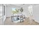 Bright dining room with modern round table, stylish chairs, and natural light from a large window at 4880 Hayride St, Las Vegas, NV 89149