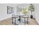 Bright dining room with round table, chairs on modern rug, and natural light from a large window at 4880 Hayride St, Las Vegas, NV 89149