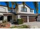 Close up shot of a well maintained two-story home with three-car garage and a beautiful yard at 4880 Hayride St, Las Vegas, NV 89149