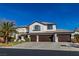 Beautiful two-story home with a three-car garage, tile roof, and large concrete driveway at 4880 Hayride St, Las Vegas, NV 89149