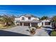 Spacious two-story home with a three-car garage, lush landscaping, and a concrete driveway at 4880 Hayride St, Las Vegas, NV 89149
