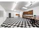 Spacious garage with work bench, overhead lighting and checkerboard floors for DIY projects at 4880 Hayride St, Las Vegas, NV 89149