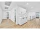 Hallway with wood-look floors and white cabinets, enhancing the home's modern design and storage capacity at 4880 Hayride St, Las Vegas, NV 89149