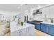 Bright, open kitchen with a large marble island and seating offers an inviting space at 4880 Hayride St, Las Vegas, NV 89149