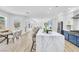 Stylish kitchen featuring an expansive island and view into living area and dining area at 4880 Hayride St, Las Vegas, NV 89149