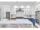 Updated kitchen features a large island with seating and stainless steel appliances at 4880 Hayride St, Las Vegas, NV 89149