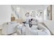 Living room featuring stylish seating, statement staircase, and custom built-in shelving at 4880 Hayride St, Las Vegas, NV 89149