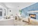 Bright living room with fireplace, white sofa, and natural light from large windows at 4880 Hayride St, Las Vegas, NV 89149