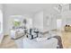 Bright living room with modern sofas, light hardwood floors, archways, and abundant natural light at 4880 Hayride St, Las Vegas, NV 89149