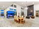 Elegant dining room featuring a fireplace, chandelier, and seamless outdoor access with a fire pit at 5184 Steel Hammer Dr, Las Vegas, NV 89135