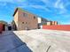 Large backyard with a concrete patio, brick fence, and ample space for outdoor activities at 5288 Emelita St, Las Vegas, NV 89122