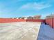 Spacious backyard with a concrete patio, brick fence, and room for landscaping at 5288 Emelita St, Las Vegas, NV 89122