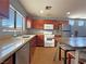 Well-lit kitchen featuring stainless steel appliances, wood cabinets, and wood-look flooring at 5288 Emelita St, Las Vegas, NV 89122