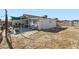 Wide shot of the large dirt backyard, house, and partial patio at 53 Montello Ave, Las Vegas, NV 89110