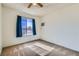 Carpeted bedroom with window, neutral wall color, and ceiling fan at 53 Montello Ave, Las Vegas, NV 89110