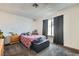 Comfortable bedroom with carpet flooring, a window, and dark colored curtains at 53 Montello Ave, Las Vegas, NV 89110