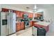 Functional kitchen featuring stainless steel appliances, wood cabinetry, and a breakfast bar at 53 Montello Ave, Las Vegas, NV 89110
