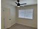 Cozy bedroom features a ceiling fan, window, and a white door, all complemented by light wood flooring at 6117 Iris Cir, Las Vegas, NV 89107