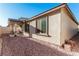 The backyard shows neutral stucco exterior and rock landscaping, providing a low-maintenance outdoor space at 617 Abrazar Ave, North Las Vegas, NV 89081