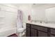 Bathroom with a tub shower, granite countertops, cabinets, and a decorative shower curtain at 617 Abrazar Ave, North Las Vegas, NV 89081