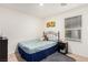 Welcoming bedroom with a metal bed frame, a window, and a sunflower painting at 617 Abrazar Ave, North Las Vegas, NV 89081