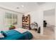 Bright bedroom featuring a large bookcase, a desk, and a window with natural light at 617 Abrazar Ave, North Las Vegas, NV 89081