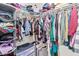 Walk-in closet is equipped with ample shelving and hanging space for storage at 617 Abrazar Ave, North Las Vegas, NV 89081