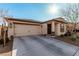 Charming single-story home featuring a two car garage, neutral stucco, and desert landscaping at 617 Abrazar Ave, North Las Vegas, NV 89081