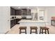Modern kitchen with granite countertops, stainless steel appliances, and an island with bar seating at 617 Abrazar Ave, North Las Vegas, NV 89081