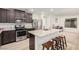 Bright kitchen with a central island, modern appliances, and dark wood cabinets at 617 Abrazar Ave, North Las Vegas, NV 89081