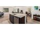 Kitchen with island, stainless steel dishwasher, and an open view of dining and living areas at 617 Abrazar Ave, North Las Vegas, NV 89081