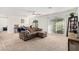 Large living room featuring carpet flooring, white walls and sliding glass door leading to backyard at 617 Abrazar Ave, North Las Vegas, NV 89081
