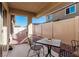 This backyard patio area includes a table and chairs for outdoor seating, perfect for relaxing or entertaining guests at 617 Abrazar Ave, North Las Vegas, NV 89081