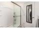 Clean shower with sliding glass door and built-in shelving, located next to the door and walk in closet at 617 Abrazar Ave, North Las Vegas, NV 89081