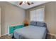 Well-lit bedroom with a bed, wooden floors, blue dresser and natural light from the window at 6254 Peach Orchard Rd, Las Vegas, NV 89142