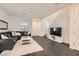 Bright living room featuring hardwood floors, neutral decor, and a comfortable sectional sofa at 690 Last Dance Pl, Henderson, NV 89011