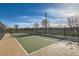 Community tennis court surrounded by a black fence on a sunny day at 690 Last Dance Pl, Henderson, NV 89011