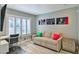 Cozy bedroom with a convertible sofa bed, window with plantation shutters, modern art, and a dedicated workspace at 6925 Emerald Springs Ln, Las Vegas, NV 89113