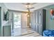 Stylish bedroom featuring ample storage space with closet, a modern ceiling fan, and balcony access at 6925 Emerald Springs Ln, Las Vegas, NV 89113