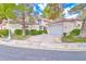 Charming home featuring a red tile roof, stucco siding, well-manicured landscaping, and an attached two-car garage at 6925 Emerald Springs Ln, Las Vegas, NV 89113