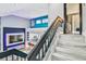 Bright living room showcasing the stairs, with a modern fireplace and open floor plan with easy access to kitchen at 6925 Emerald Springs Ln, Las Vegas, NV 89113