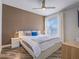 Comfortable bedroom with ceiling fan, large window, and wood-look flooring at 7111 S Durango Dr # 305, Las Vegas, NV 89113