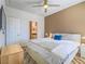 Bright bedroom boasts a ceiling fan, wood-look floors, and a connected bathroom at 7111 S Durango Dr # 305, Las Vegas, NV 89113
